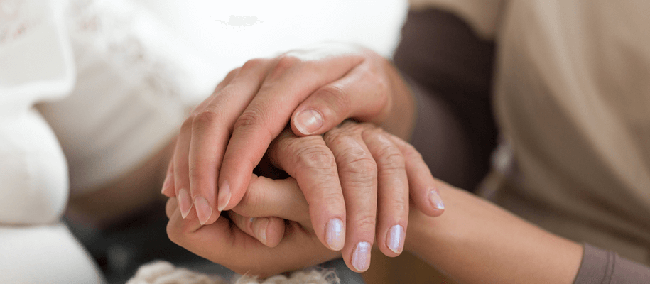 a picture of a caregiver and a senior at a respite care facility.