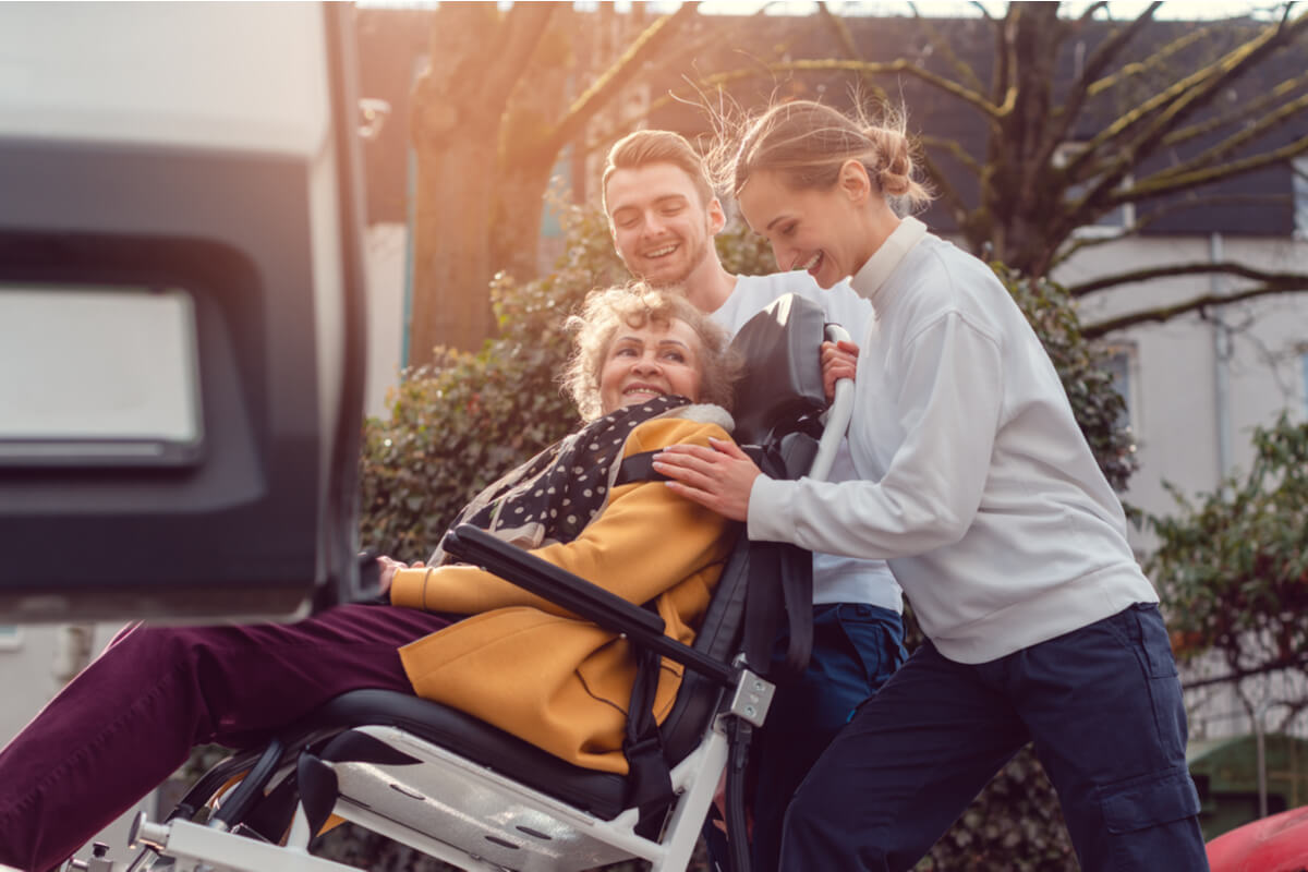 A woman being helped with non emergency medical transportation at a recuperative care center.