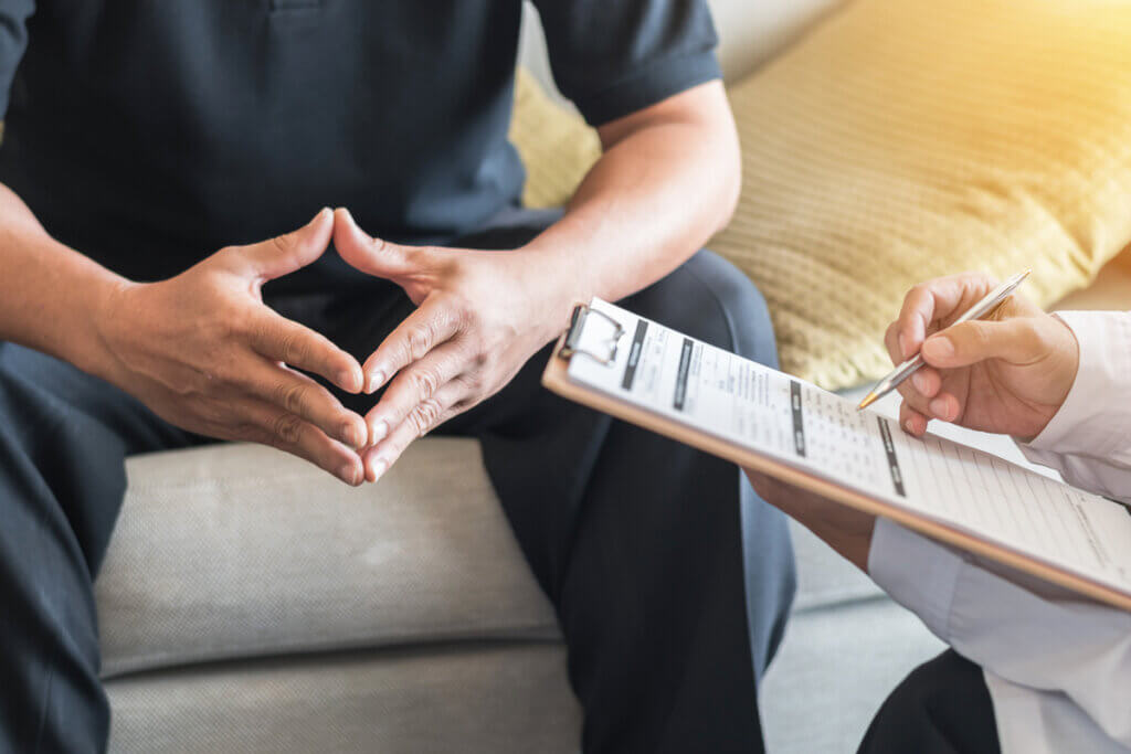 A patient and staff engaging in mental health care in a transitional facility.