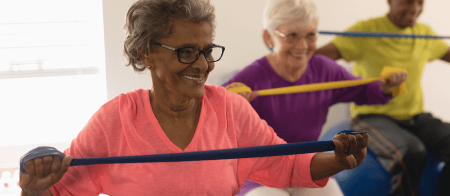 A group of seniors exercising in a recuperative care facility.